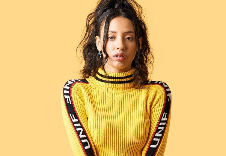 model wearing yellow jumper