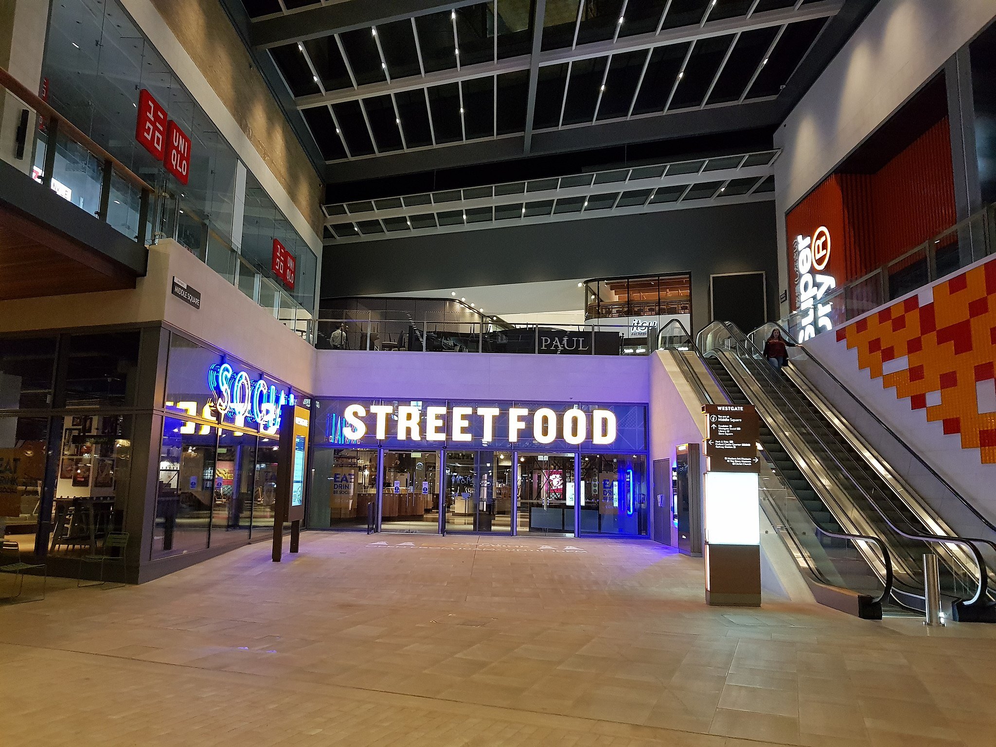 View inside Westgate Shopping Centre showing Westgate Streetfood, with escalators on the right side