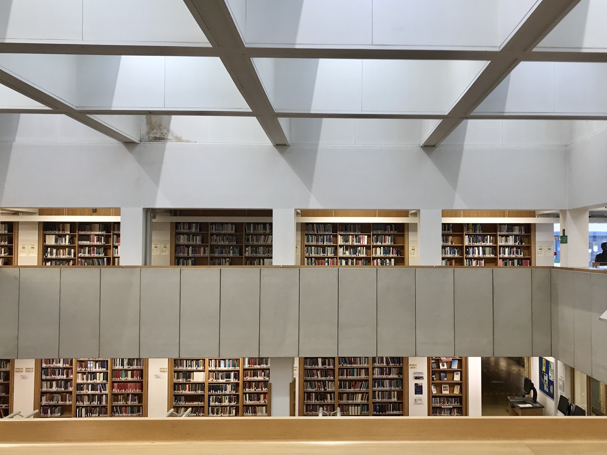 A photo taken from the top floor of the English Faculty Library, showing bookshelves. 