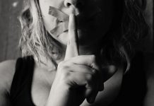 Image of a woman with her mouth taped