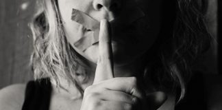 Image of a woman with her mouth taped