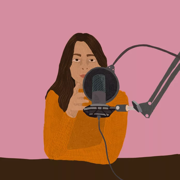 Woman speaking into a podcast microphone