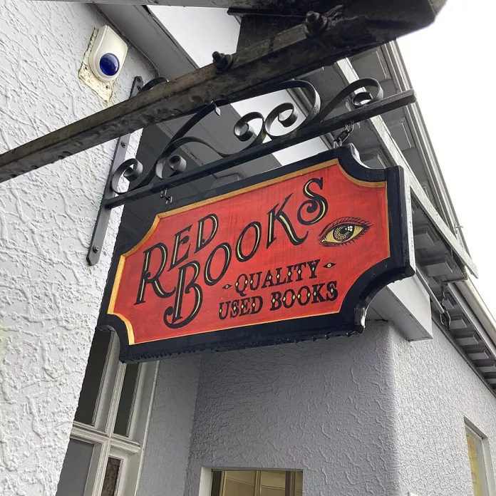 Book store sign reading 'Red Books: quality used books'.