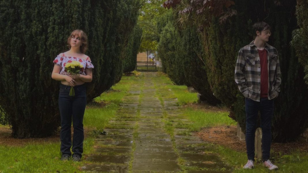 Woman and man standing in garden
